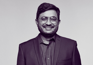 Dr Sabar, an oncologist, wearing a suit and smiling at the camera