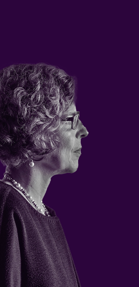 An Oncologist against a plain purple background
