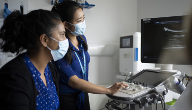 Trainee and consultant radiologists, conducting an ultrasound consultation 