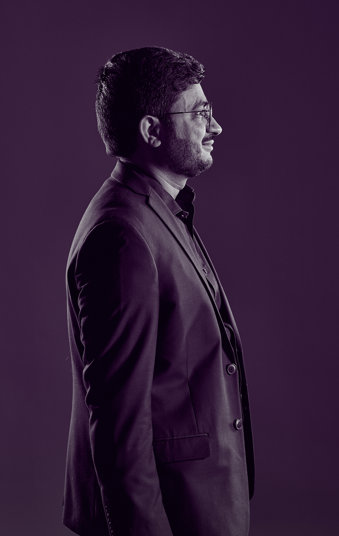 Dr Sabar, an oncologist, wearing a suit, standing in profile for the camera